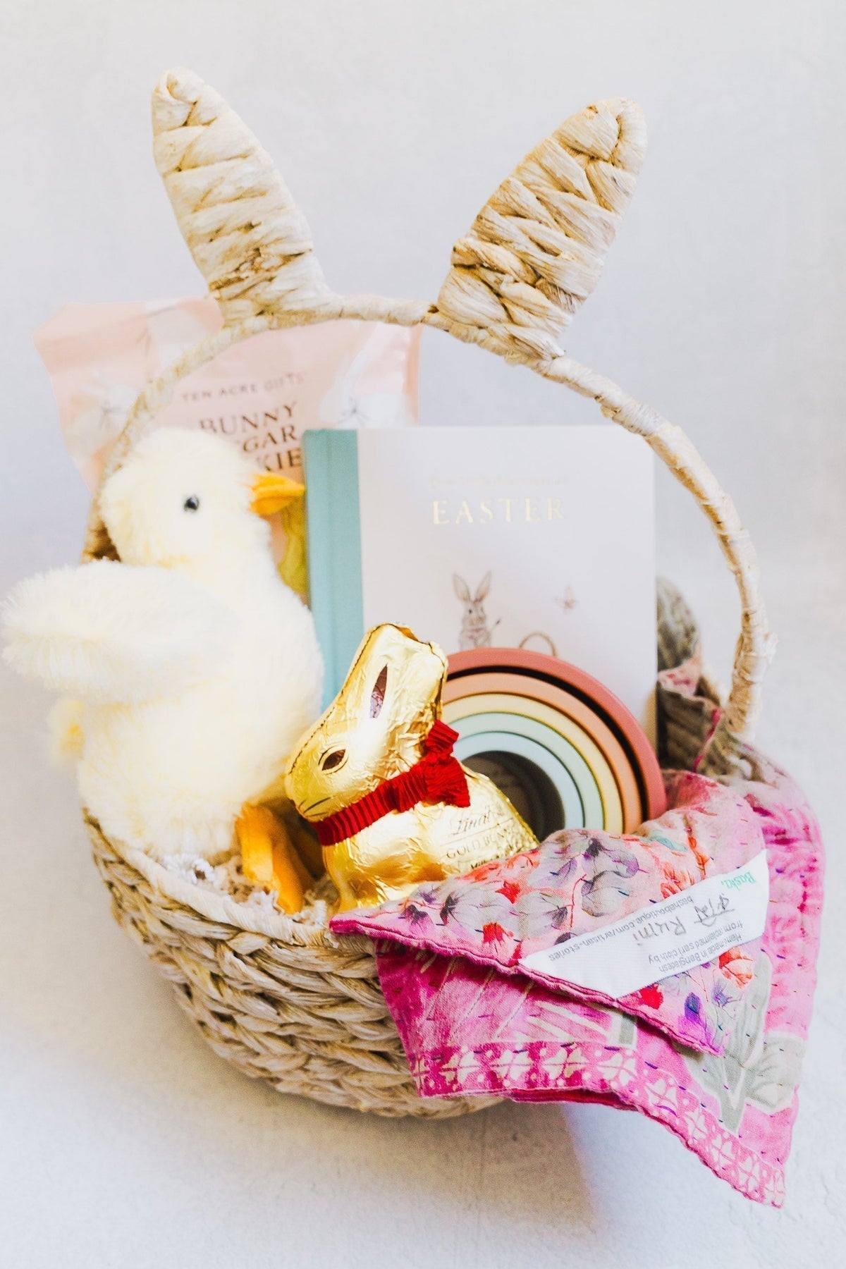 Mini baby Kantha blanket sitting inside an easter basket with toys